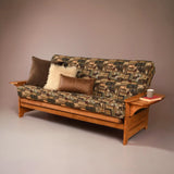 Wooden futon with patterned cushion and pillows against a plain background